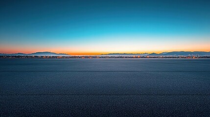a plane that is sitting on the runway at sunset