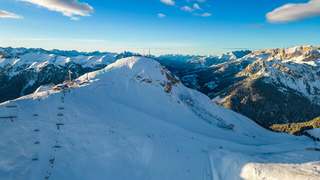 The Stazione di Arrivo Funivia Campitello and the Forcella del Sassolungo stand out in the breathtaking Val di Fassa ski resort in winter time captured by drone