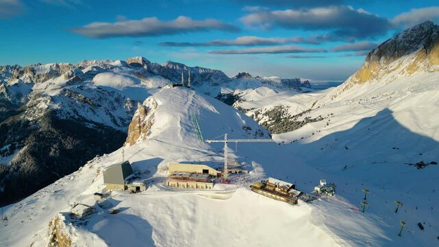 The Stazione di Arrivo Funivia Campitello and the Forcella del Sassolungo stand out in the breathtaking Val di Fassa ski resort in winter time captured by drone