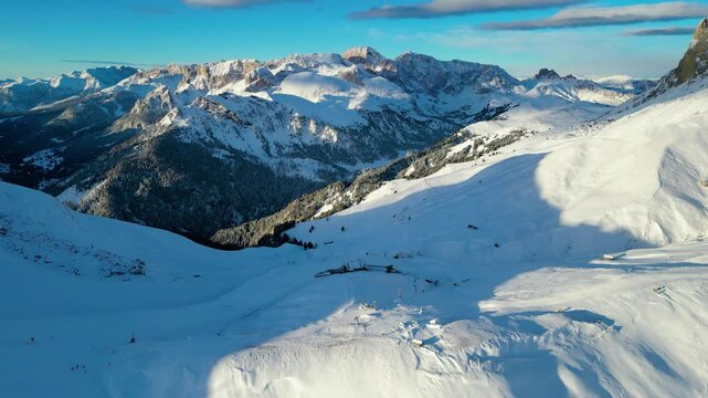 The Stazione di Arrivo Funivia Campitello and the Forcella del Sassolungo stand out in the breathtaking Val di Fassa ski resort in winter time captured by drone