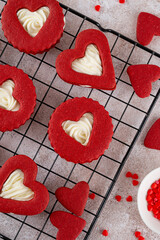 Red velvet sandwich cookies in the shape of a heart with cream cheese filling for Valentines day. Holiday dessert. Copy space.
