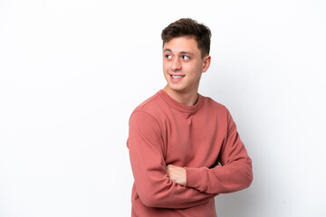 Young handsome Brazilian man isolated on white background looking to the side and smiling
