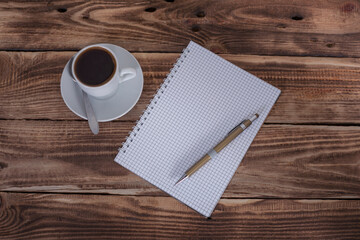 Open notebook with pen and coffee in studio