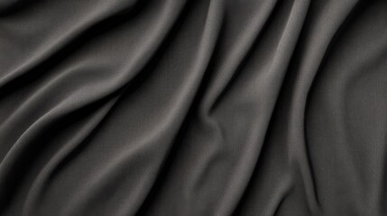 Obraz premium Abstract dark gray fabric texture with soft folds and wrinkles.