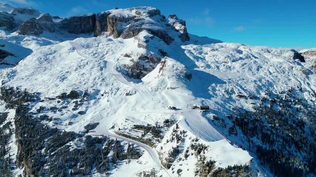 Gruppo del Sella and the famous Sellaronda ski circuit shine in this breathtaking winter aerial view, captured by drone. The Piz Bo&egrave; station on the Alta Badia ski resort reveals its alpine charm