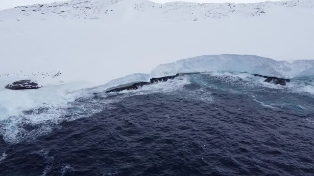 South Atlantic Ocean. Waves hitting an spring Antarctic glacier. Aerial shot. Ecology in the world. Ice melting protection. 
