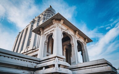 Obraz premium Low angle view of ornate white temple against blue sky.