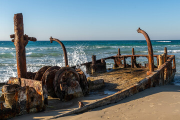 Abandoned rusty shipwreck at HaBonim Beach Nature Reserve on the Mediterranean Sea in Israel.
