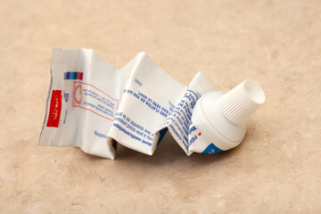 completely squeezed tube of toothpaste as a symbol of exhaustion of resources, energy, or effort,...