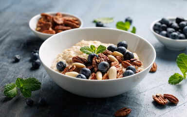 Oatmeal porridge with blueberry, almonds, and pecan healthy breakfast.