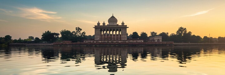 Fototapeta premium Sunrise over serene lake reflecting ancient architecture.