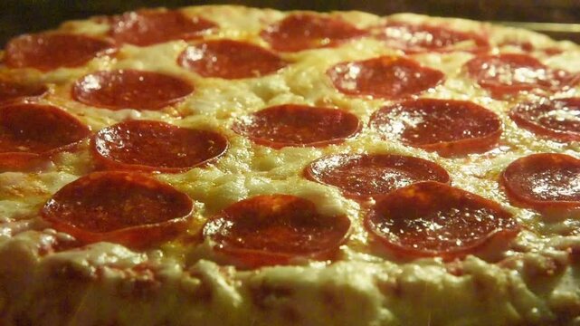 Closeup of a pepperoni pizza Cooked inside a hot oven with the cheese bubbling for a home cooking meal or food concept.