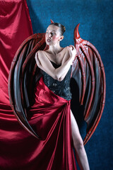 Fototapeta premium lady with dragon wings on red and blue background
