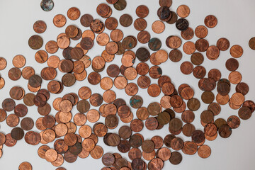 Scattered copper coins on a white background.