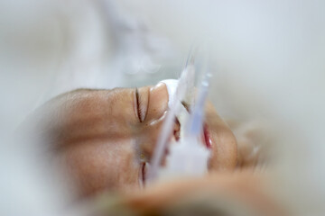 Closeup lovely little newborn baby infant lying in incubators for newborns, Newborn baby having the...