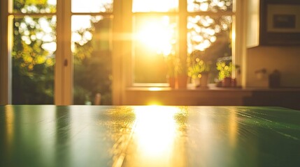 Fototapeta premium A green table surface contrasts with a bright, cozy kitchen, golden sunlight streaming through windows, creating a warm bokeh effect.