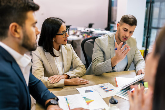 Workers group and team leader having teamwork discussion managing project at work in meeting room.