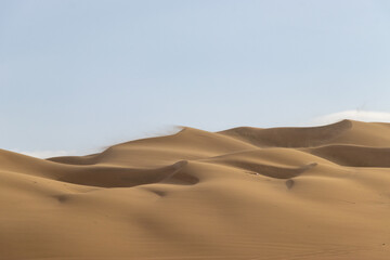 The sand dunes of Huacachina, Peru are a very popular tourist spot, where many try sandboarding or driving dune buggies.