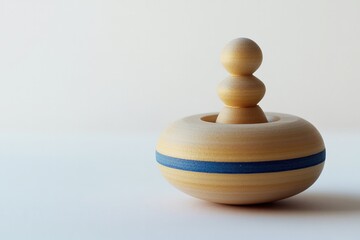 Elegant wooden spinning top features smooth lines and subtle col