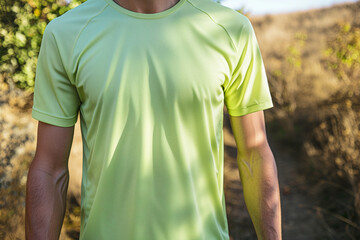 Naklejka premium Light Green Athletic T-Shirt Mockup on Male Runner Enjoying Sunny Trail Running Adventure in Nature