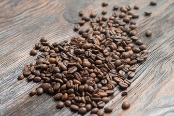 Coffee beans on the dark wooden background