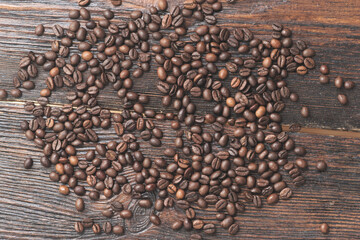Coffee beans on the dark wooden background
