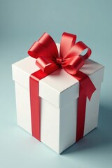 Obraz premium Red gift bow tied neatly on a white cardboard box, package, gift