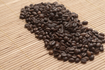 Coffee beans on the dark wooden background