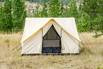 tent structure front view, pristine white canvas, natural environment