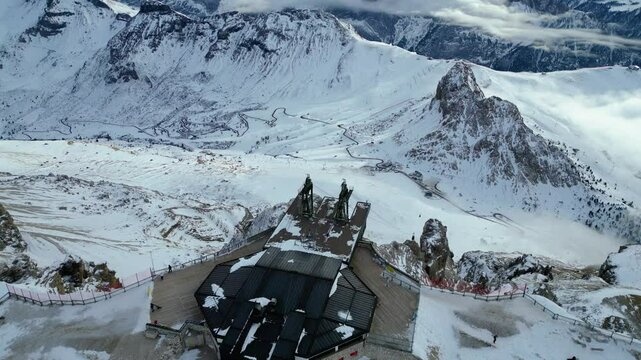 Stazione a Monte - Funivia Sass Pordoi in winter offers an unforgettable experience in the heart of the Dolomites. Captured by drone, the scene showcases the snowy summit station Passo Pordoi below