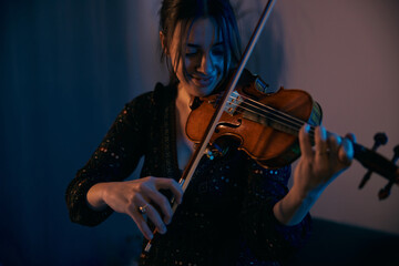 Fototapeta premium Female Violinist is Preparing for a Concert