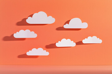 layered paper clouds against rose-gold sky