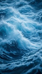Fototapeta premium Dynamic ocean waves with foamy crests and dark blue depths showing nature's raw power