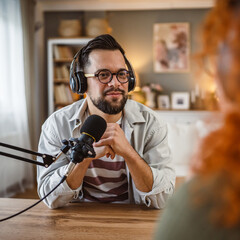adult man host interviewer woman guest questions while record podcast