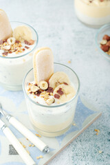 Milk mousse dessert with nuts in glasses	