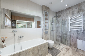 Bright Elegant Modern Minimalist Bathroom Interior Design of Shower Room With White Sink. Bathroom Accessories, Gray Tile Walls, Mirror, Washing Machine and Faucet. LED Light.