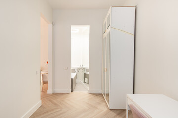 Minimalism Children, Young Adult Living Room Interior. Desk, Table Wardrobe Closet in Background. Open Door to Bathroom. White Walls and Ceiling. LED Light