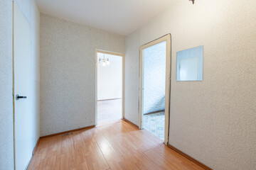 Home Entrance Hall Interior. Wooden Brown Door, Flooring. Minimalism. LED Light. Corridor, Hallway. White Doors to WC and Bathroom