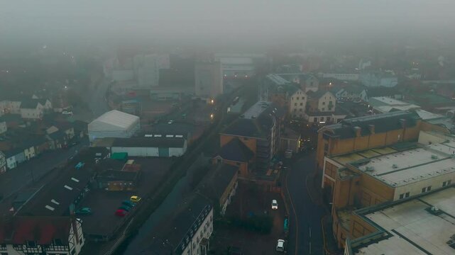 Aerial drone cityscape shot with fog covered the town in winter season