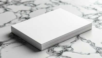 A stack of white paper is on a marble countertop