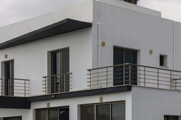 Modern architecture shines under cloudy skies in an urban neighborhood