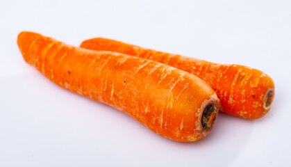 Fresh uncooked washed carrots isolated on a white background