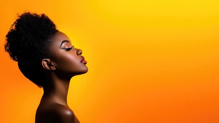 Elegant Black woman with dark skin posing against vibrant orange-yellow gradient background
