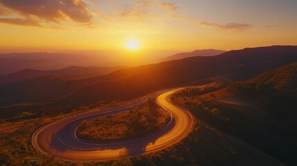 Fototapeta premium Sunset illuminates winding mountain road.