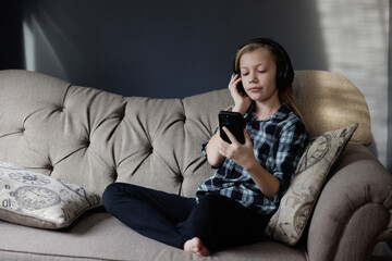 Portrait of girl listening to music. Relaxing in Living Room