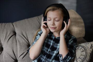 Portrait of girl listening to music. Relaxing in Living Room