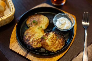 Fried grated potato pancakes with sour cream and dill, traditional Belarusian dish draniki