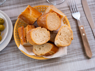 Sliced freshly baked traditional french bread served for dinner in a cafe