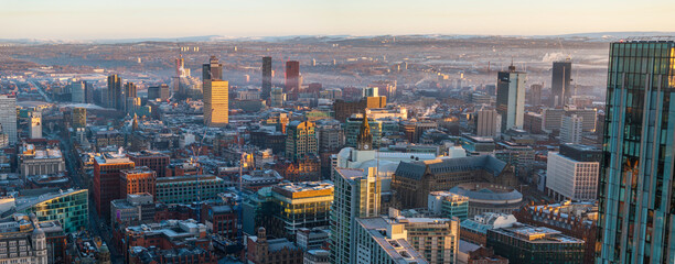 Fototapeta premium Panoramic aerial image of Manchester's frosty cityscape during the morning sunrise. 