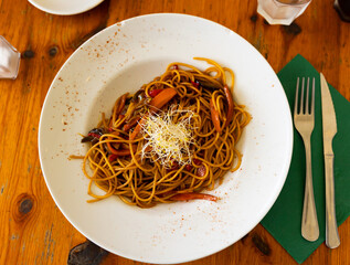 Delicious pasta with vegetables and soy sauce served on plate